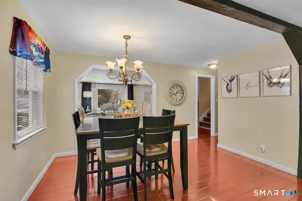 a view of a dining room with furniture and chandelier