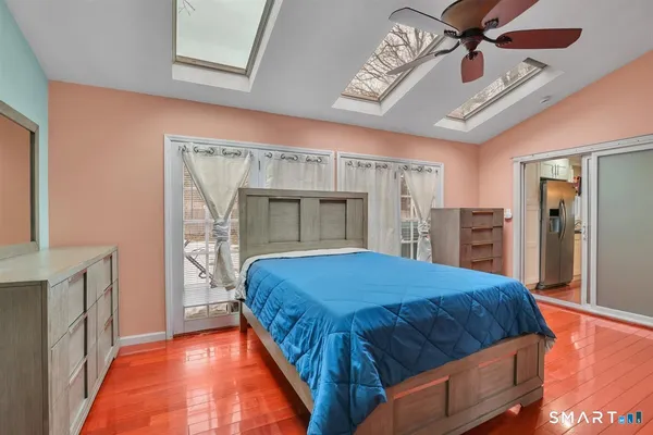 a bedroom with a large bed and a chandelier