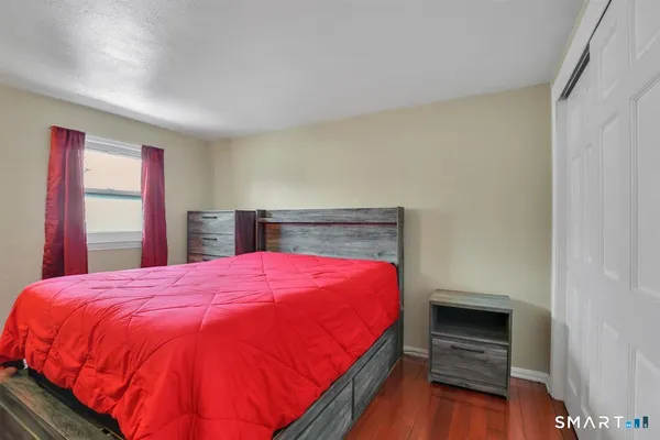 a bedroom with a bed and a dresser