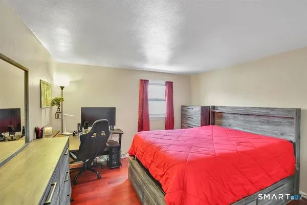 a bed sitting in a bedroom next to a window
