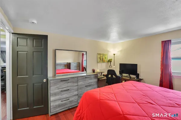 a room with a bed and a flat screen tv