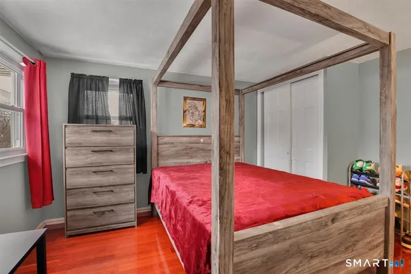 a bedroom with a bed and a dresser