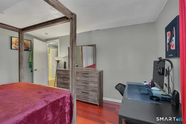 a bedroom with a bed and a desk