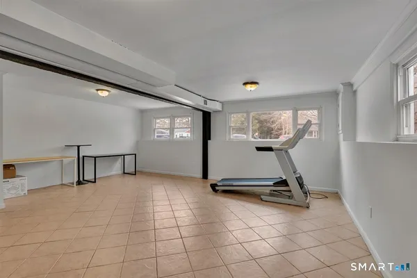 a view of a room with gym equipment and a large window