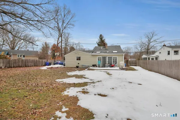 a view of a house with snow on the road