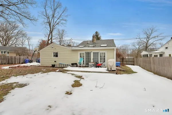 a view of a house with snow on a road