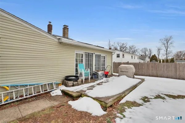 a view of a patio with a table and chairs