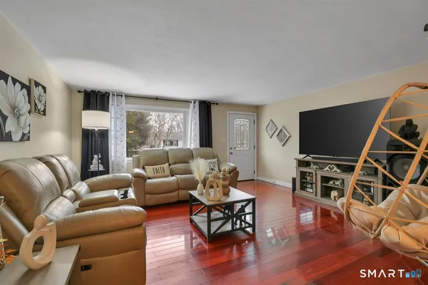 a living room with furniture and a flat screen tv