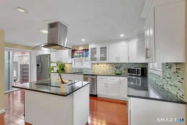 a kitchen with kitchen island granite countertop a sink and counter space