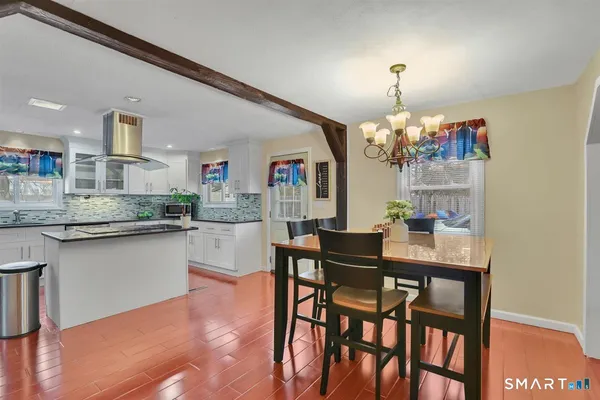 a view of a dining room with furniture and chandelier