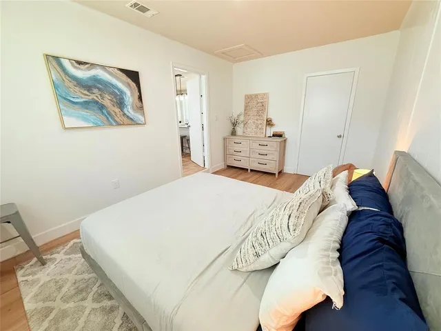 a bed sitting in a bedroom and painting on the wall
