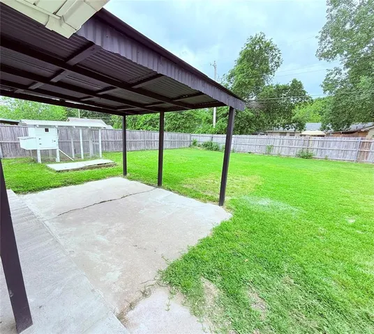 a view of a backyard with wooden fence