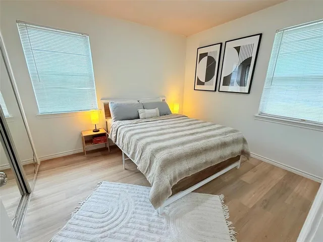 a bedroom with a bed and painting on the wall