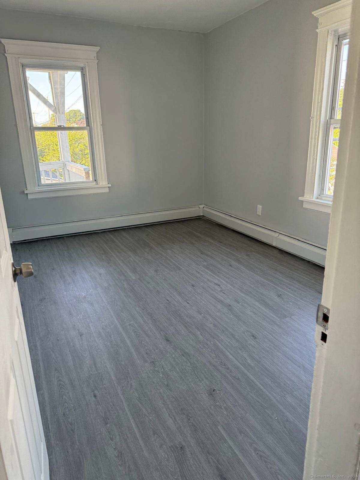 2336 Barnum Avenue, Unit FRONT E Stratford, CT 06615 - Photo 10 of 12 an empty room with a window