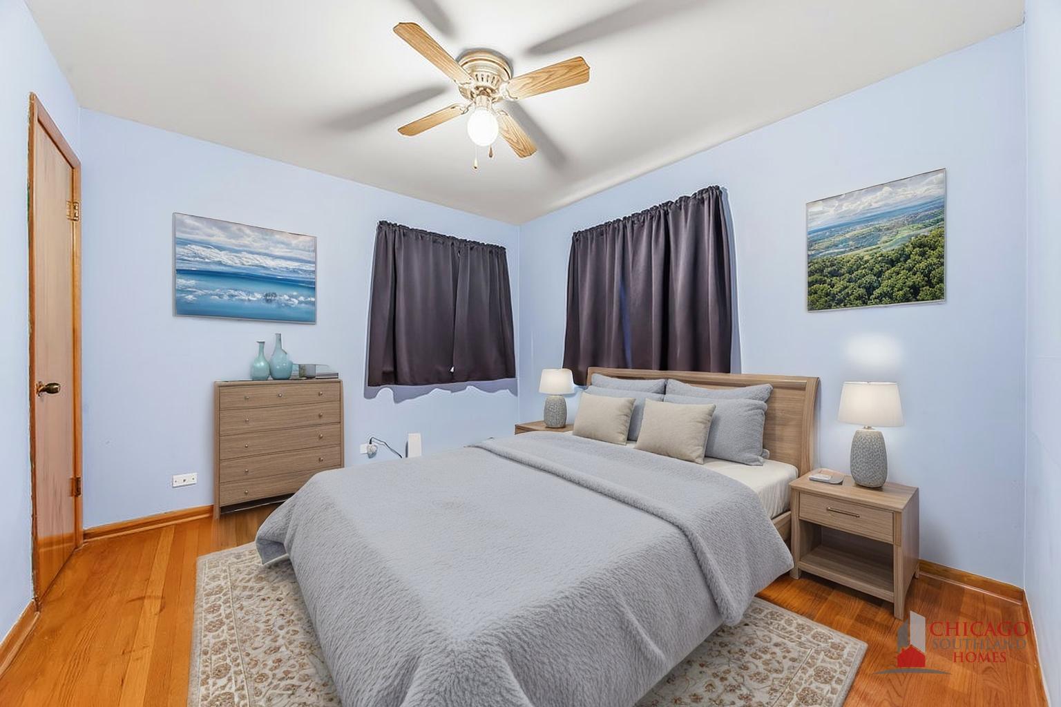 22 Charing Cross Road Chicago Heights, IL 60411 - Photo 18 of 25 a bedroom with a bed and a chandelier