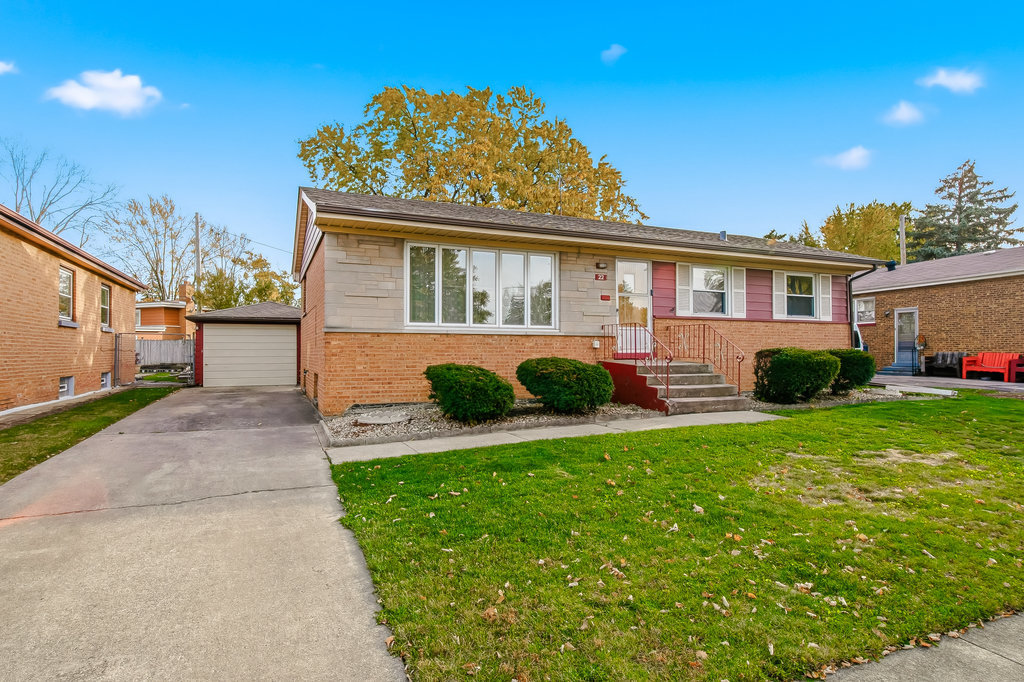 22 Charing Cross Road Chicago Heights, IL 60411 - Photo 3 of 25 a front view of a house with a garden and porch