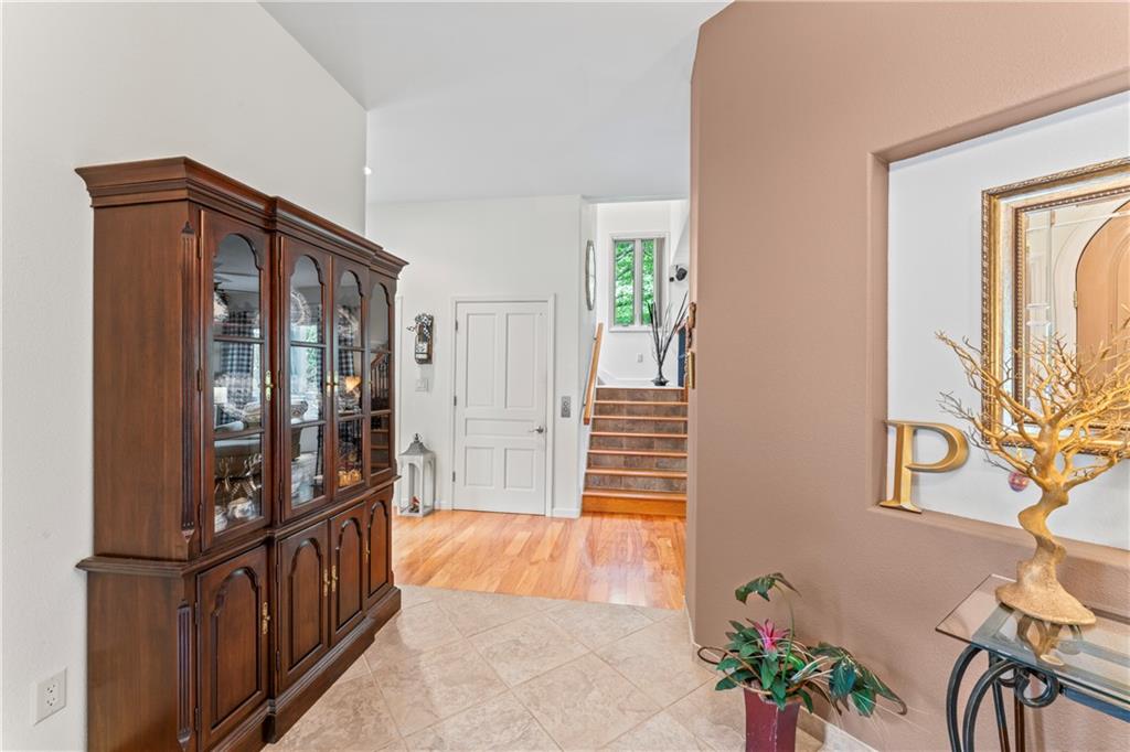 320 Holly Lane Walhalla, SC 29691 - Photo 25 of 41 This inviting entryway showcases a blend of warm wood and cool tile, leading to a charming staircase.