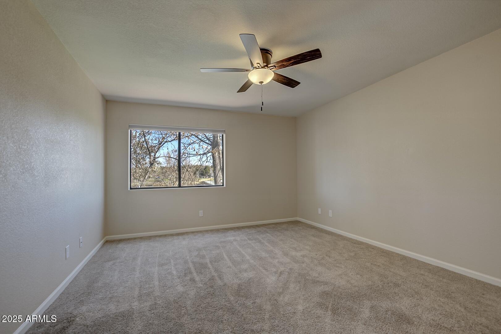 938 West Madera Lane Payson, AZ 85541 - Photo 17 of 28 an empty room with window and ceiling fan