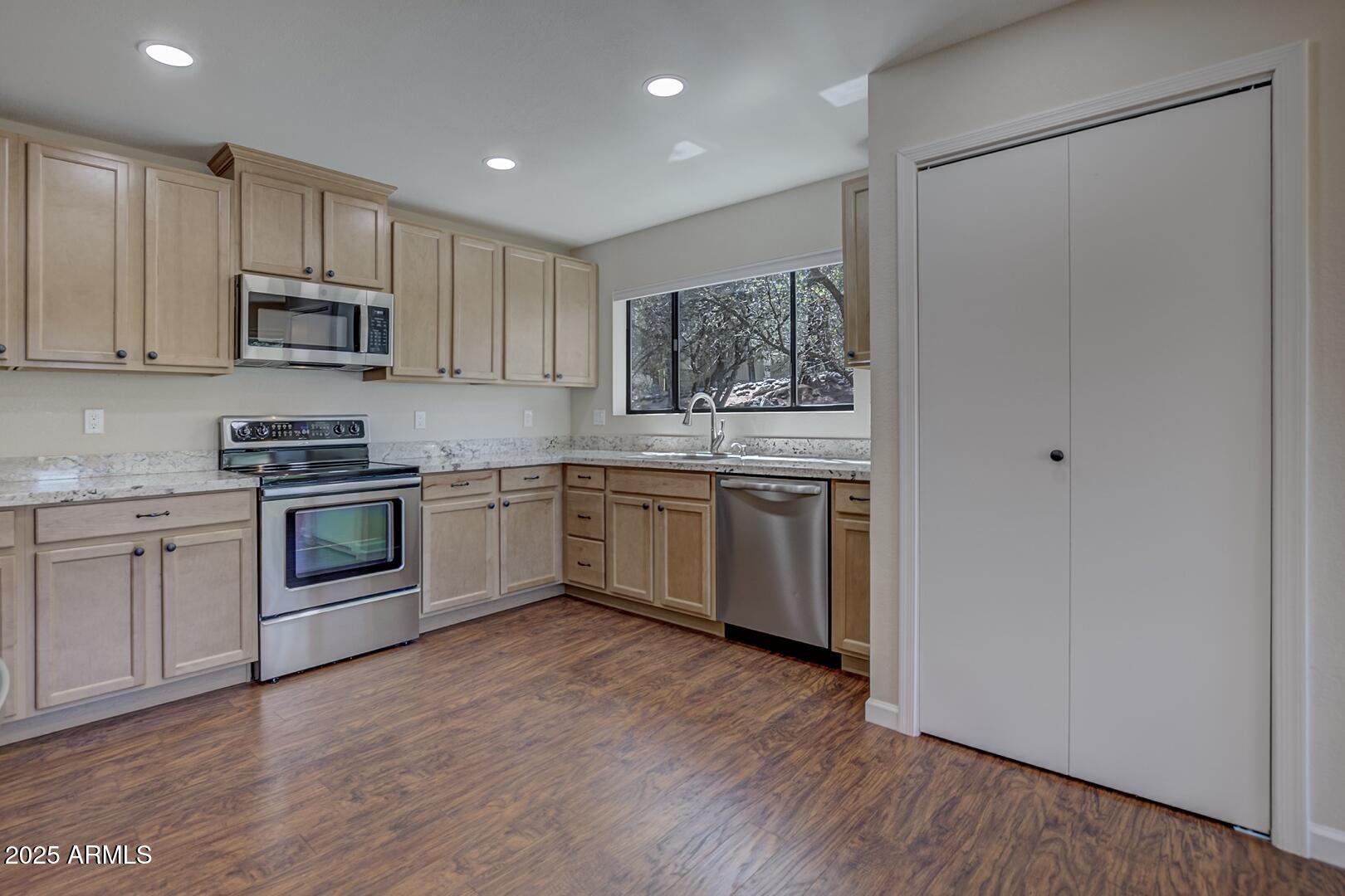 938 West Madera Lane Payson, AZ 85541 - Photo 4 of 28 a kitchen with a white cabinets and white appliances