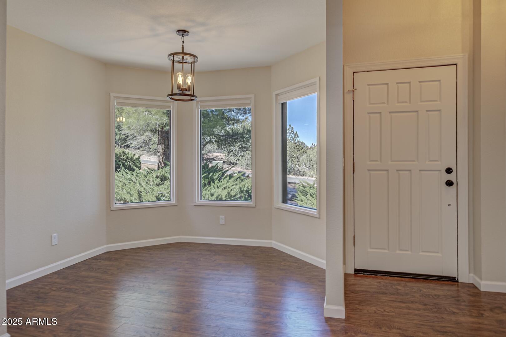 938 West Madera Lane Payson, AZ 85541 - Photo 6 of 28 an empty room with wooden floor and windows