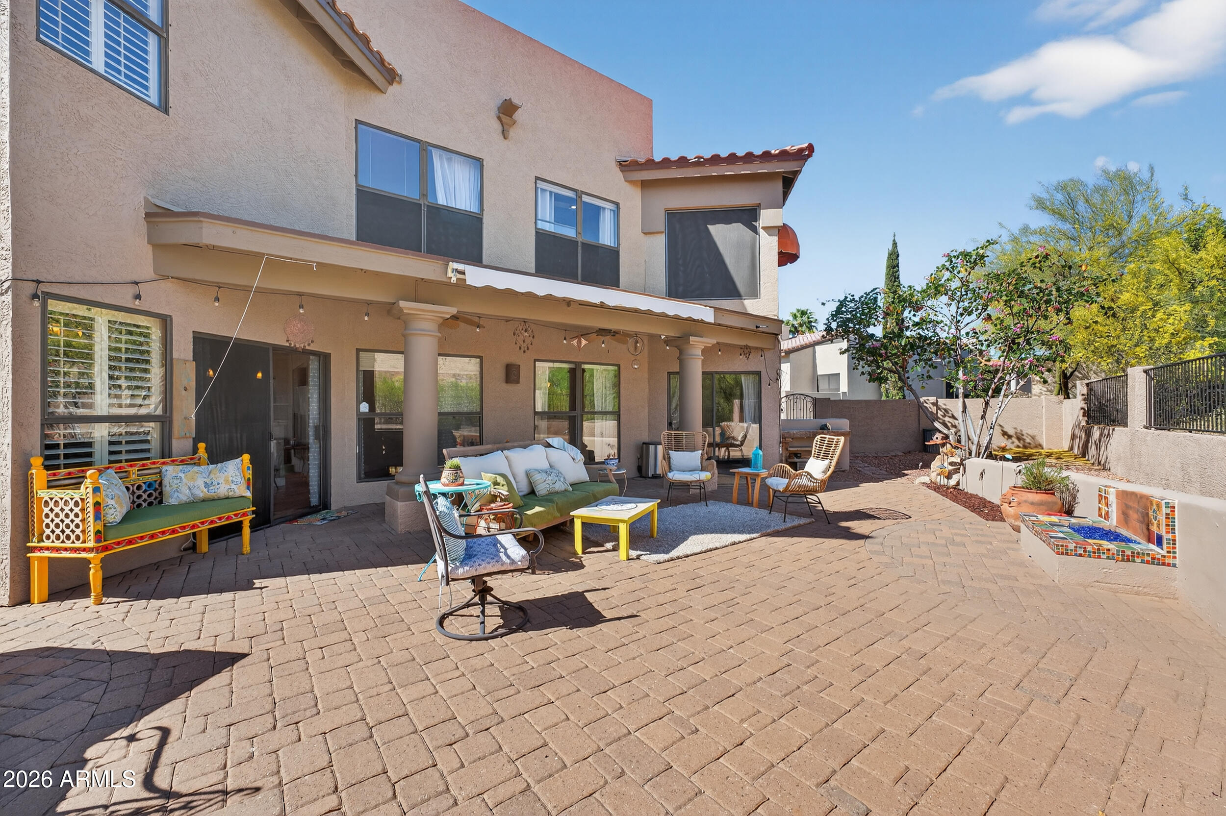 1539 East Winged Foot Road Phoenix, AZ 85022 - Photo 57 of 64 a view of a patio with dining table and chairs with wooden fence