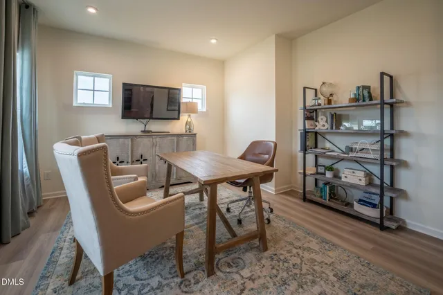 a view of a dining room with furniture and a flat screen tv