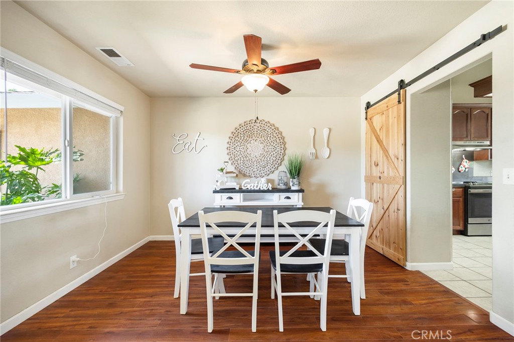 23446 Capay Road Corning, CA 96021 - Photo 17 of 64 a view of a dining room with furniture window and wooden floor