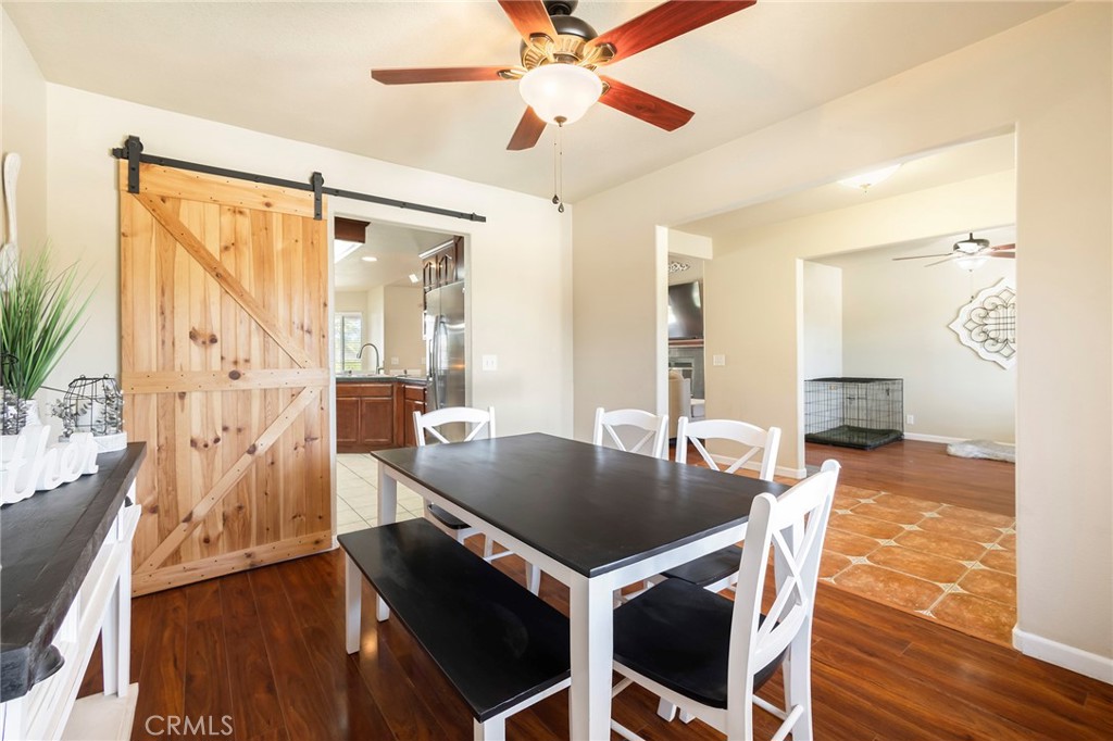 23446 Capay Road Corning, CA 96021 - Photo 18 of 64 a view of a dining room with furniture and wooden floor