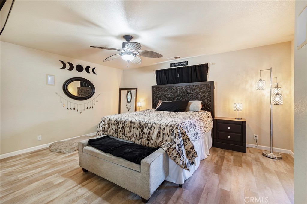 23446 Capay Road Corning, CA 96021 - Photo 19 of 64 a bedroom with a bed and wooden floor