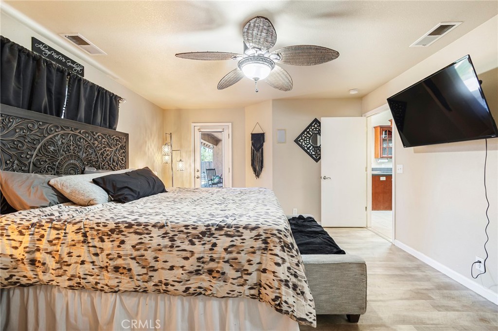 23446 Capay Road Corning, CA 96021 - Photo 20 of 64 a bedroom with a large bed and a flat screen tv