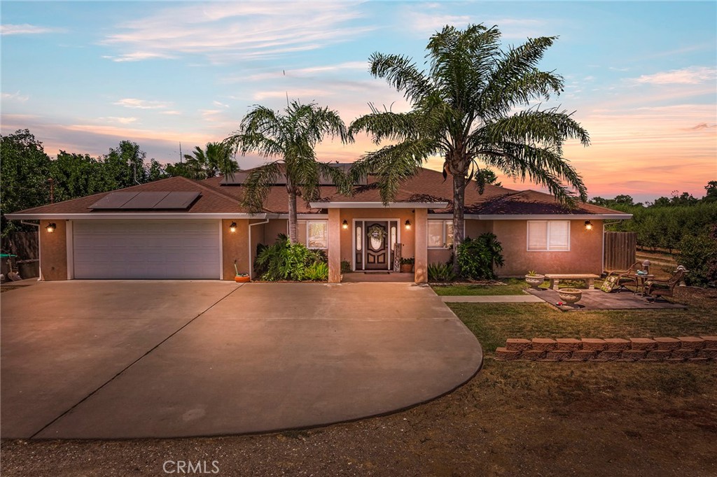 23446 Capay Road Corning, CA 96021 - Photo 2 of 64 front view of a house with a yard and potted plants