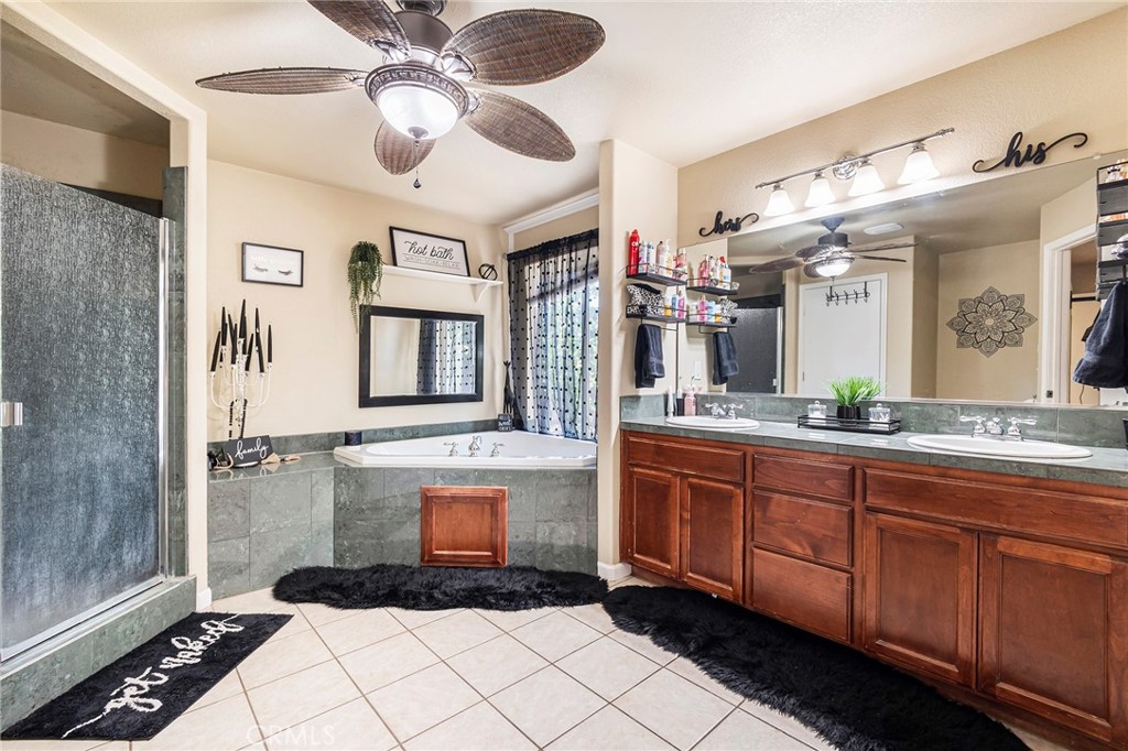 23446 Capay Road Corning, CA 96021 - Photo 22 of 64 a spacious bathroom with a sink a mirror and a shower