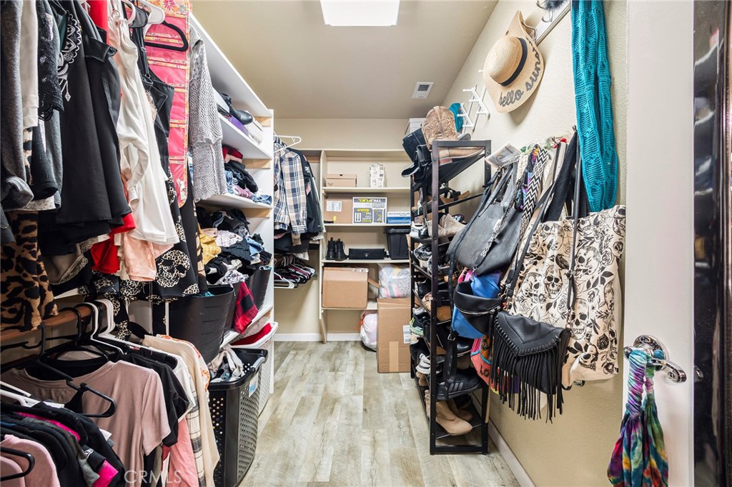 23446 Capay Road Corning, CA 96021 - Photo 25 of 64 a view of walk in closet with clothes and shoes