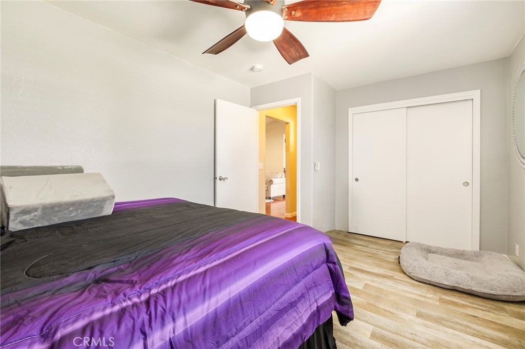 23446 Capay Road Corning, CA 96021 - Photo 27 of 64 a bedroom with a bed and a chandelier