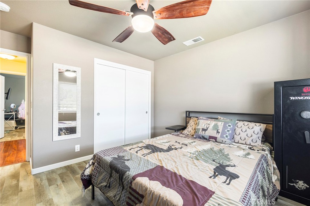 23446 Capay Road Corning, CA 96021 - Photo 32 of 64 a bedroom with a bed and a chandelier