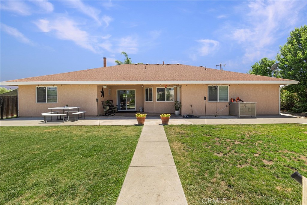 23446 Capay Road Corning, CA 96021 - Photo 36 of 64 a view of a house with backyard sitting area and garden