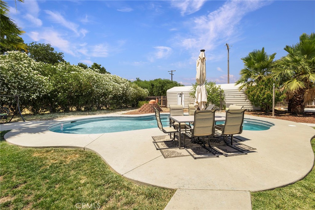 23446 Capay Road Corning, CA 96021 - Photo 42 of 64 a view of a swimming pool with sitting area
