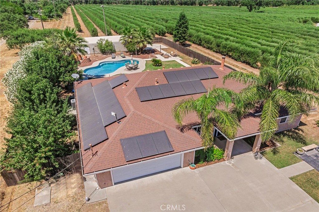 23446 Capay Road Corning, CA 96021 - Photo 52 of 64 an aerial view of a house with a garden and trees
