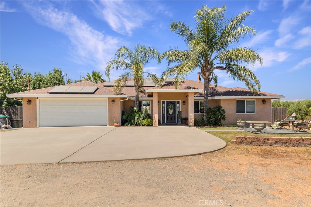 23446 Capay Road Corning, CA 96021 - Photo 6 of 64 a front view of a house with a yard and garage