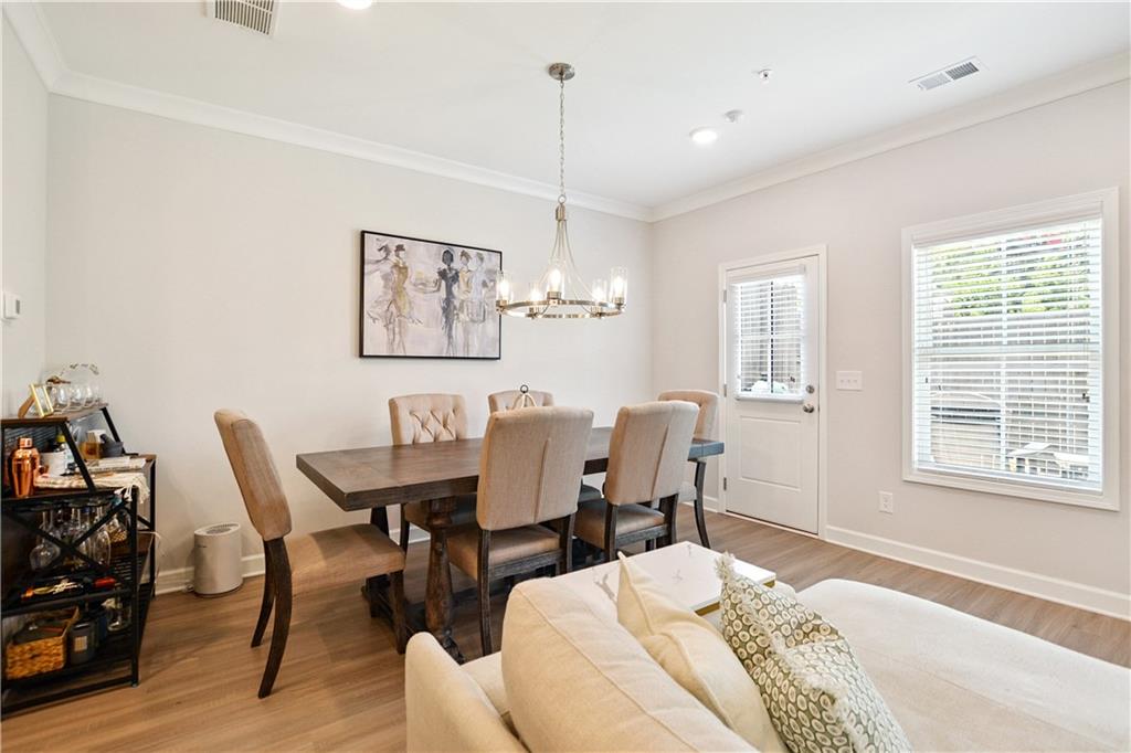 765 Trevett Way Marietta, GA 30066 - Photo 11 of 46 a view of a dining room with furniture and wooden floor