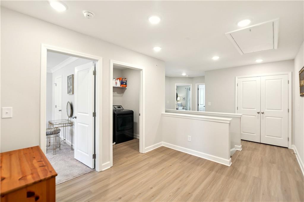 765 Trevett Way Marietta, GA 30066 - Photo 19 of 46 a view of a kitchen and an empty room with wooden floor