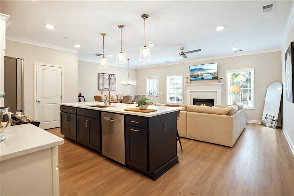 765 Trevett Way Marietta, GA 30066 - Photo 2 of 46 a living room with stainless steel appliances kitchen island granite countertop wooden floors and a view of living room