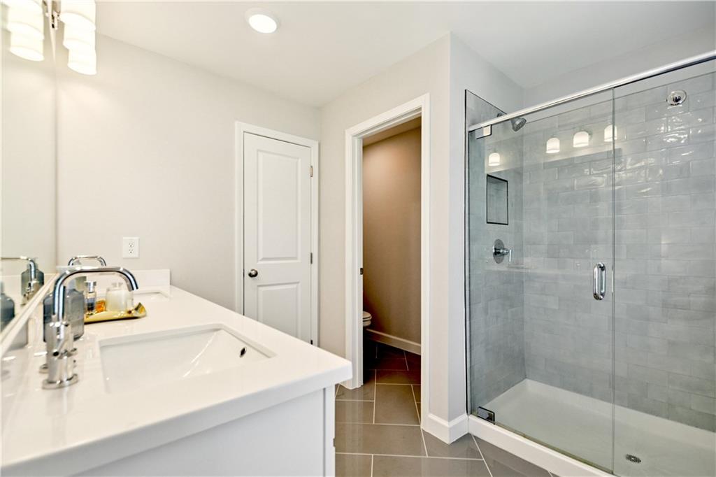 765 Trevett Way Marietta, GA 30066 - Photo 25 of 46 a bathroom with a sink mirror and shower