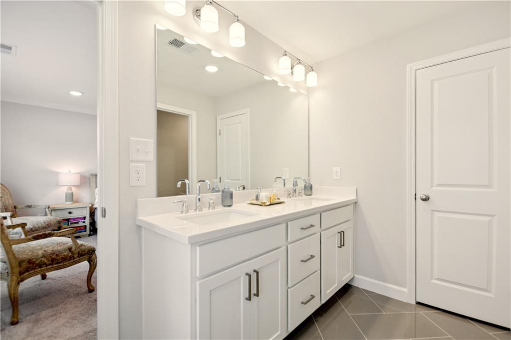 765 Trevett Way Marietta, GA 30066 - Photo 26 of 46 a en suite bathroom with a double vanity sink and a mirror