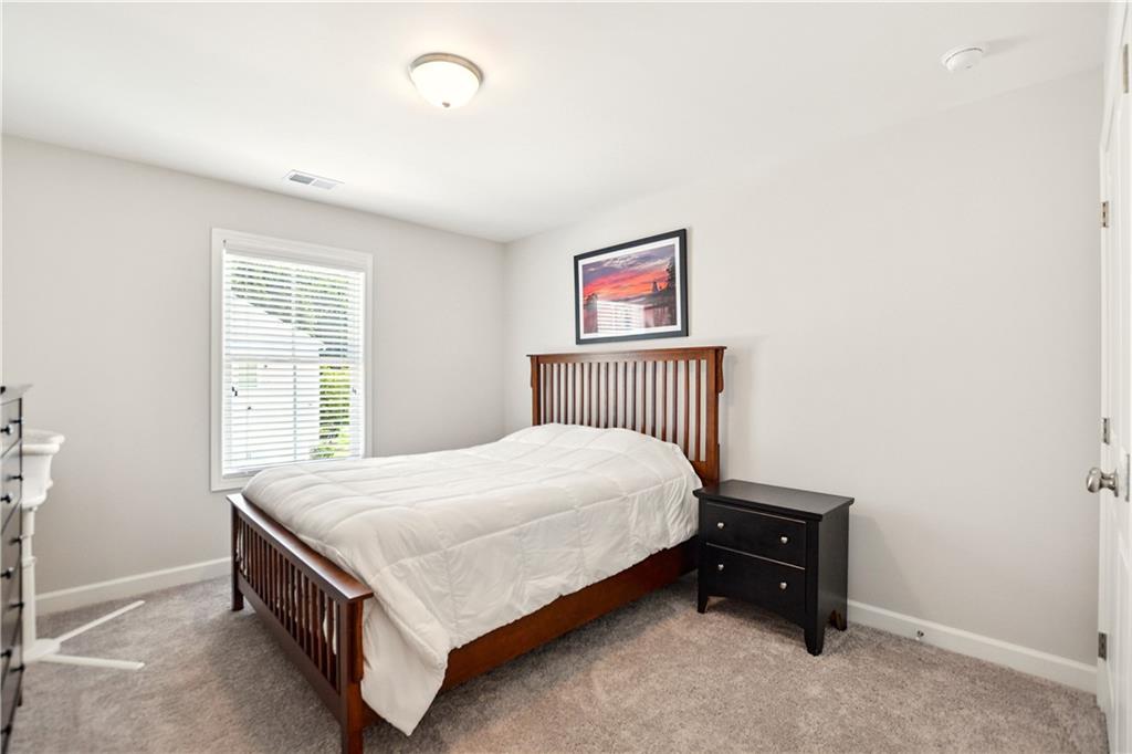765 Trevett Way Marietta, GA 30066 - Photo 30 of 46 a bedroom with a bed and a window