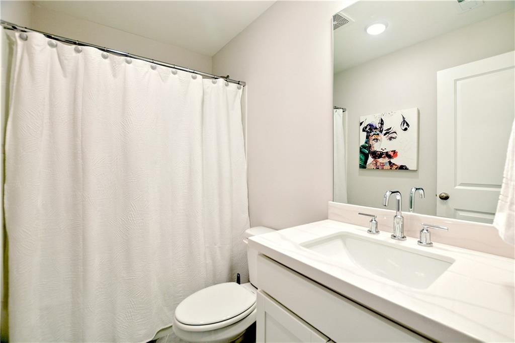 765 Trevett Way Marietta, GA 30066 - Photo 31 of 46 a bathroom with a granite countertop sink and a mirror