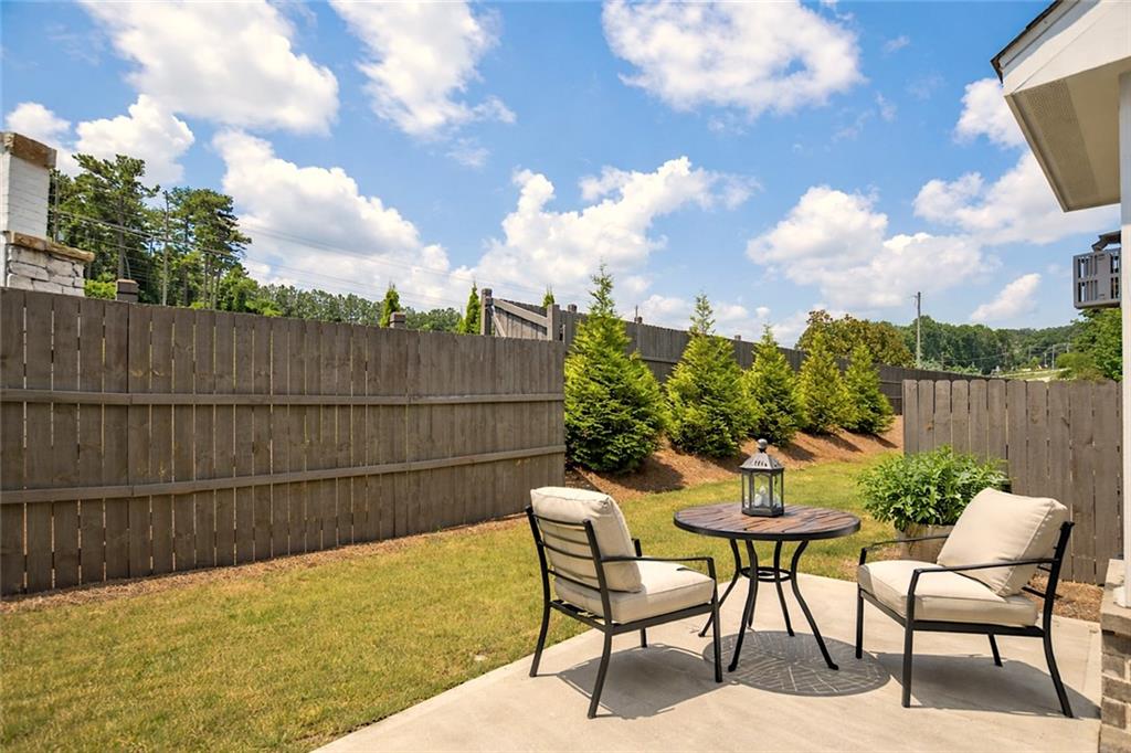 765 Trevett Way Marietta, GA 30066 - Photo 33 of 46 a view of a chairs and table in the back yard of the house