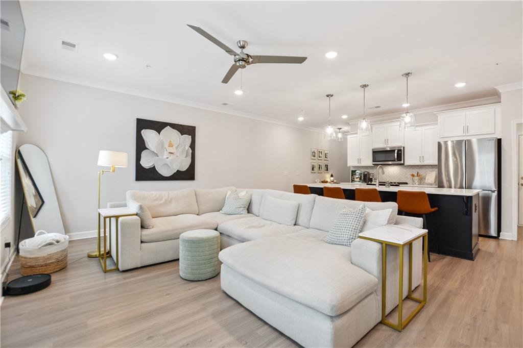 765 Trevett Way Marietta, GA 30066 - Photo 4 of 44 a living room with furniture kitchen view and a chandelier