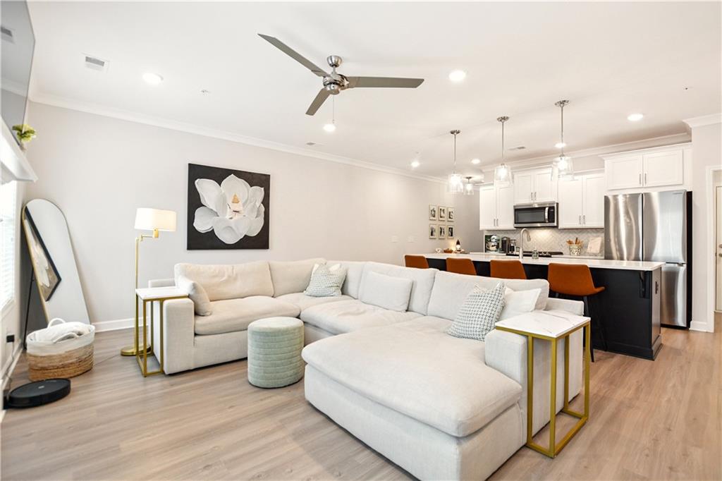 765 Trevett Way Marietta, GA 30066 - Photo 4 of 46 a living room with furniture kitchen view and a chandelier