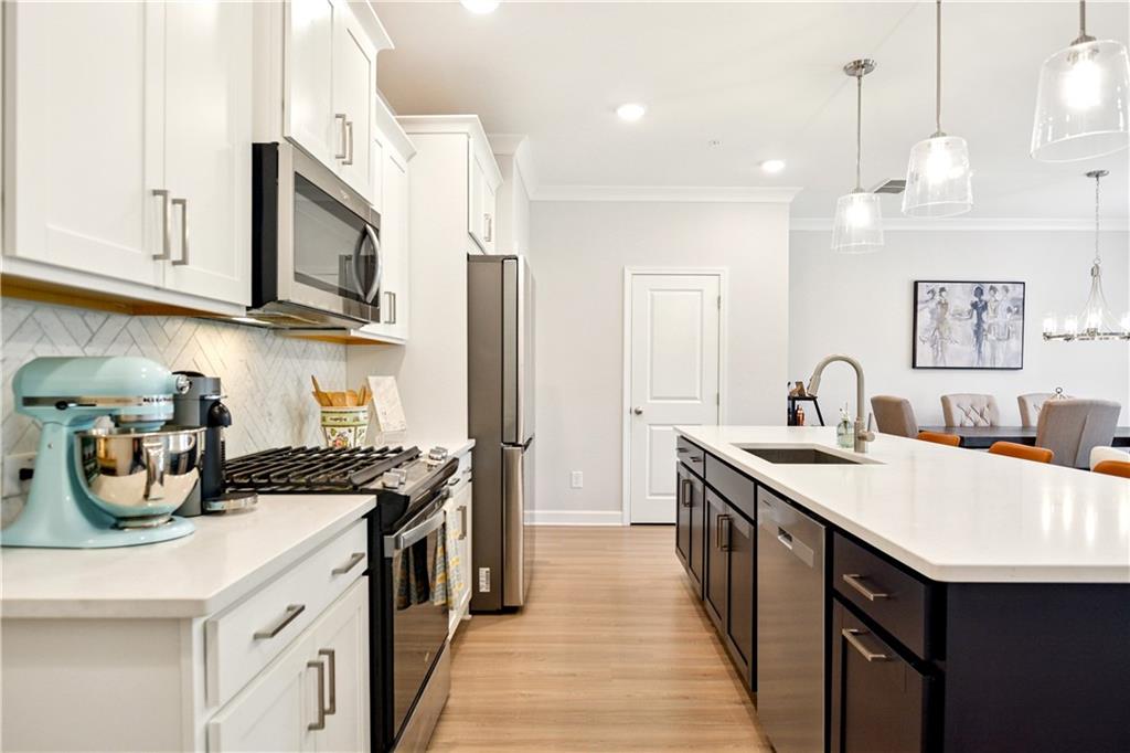 765 Trevett Way Marietta, GA 30066 - Photo 5 of 46 a kitchen with stainless steel appliances granite countertop a sink a stove and a wooden floors